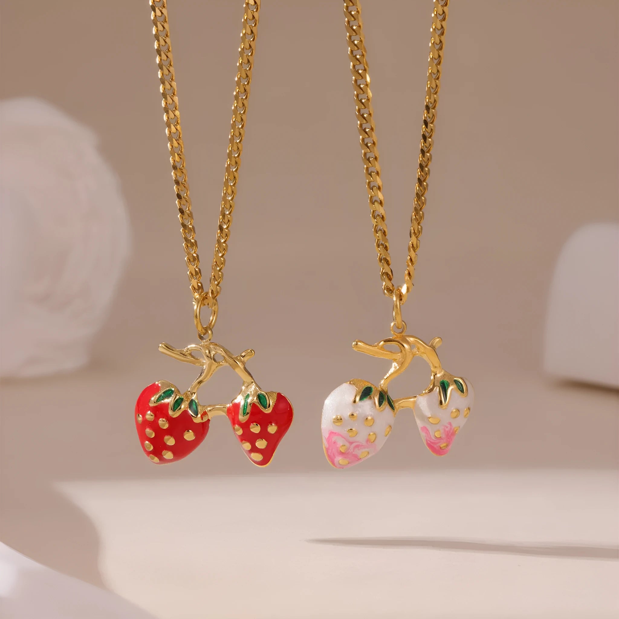 Strawberry fruit pendant necklace for women on a stainless steel chain, shown in red and white gradient colour options.