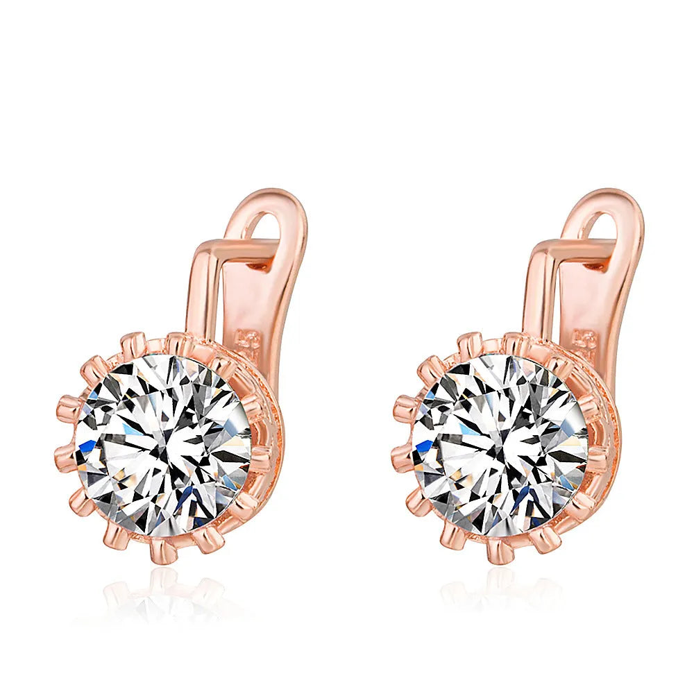 Korean retro crown design ear clip earrings in rose gold or white gold finish with white diamond accents.