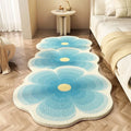 Flower-shaped cartoon print imitation cashmere blanket in a gradient colour on a sofa.