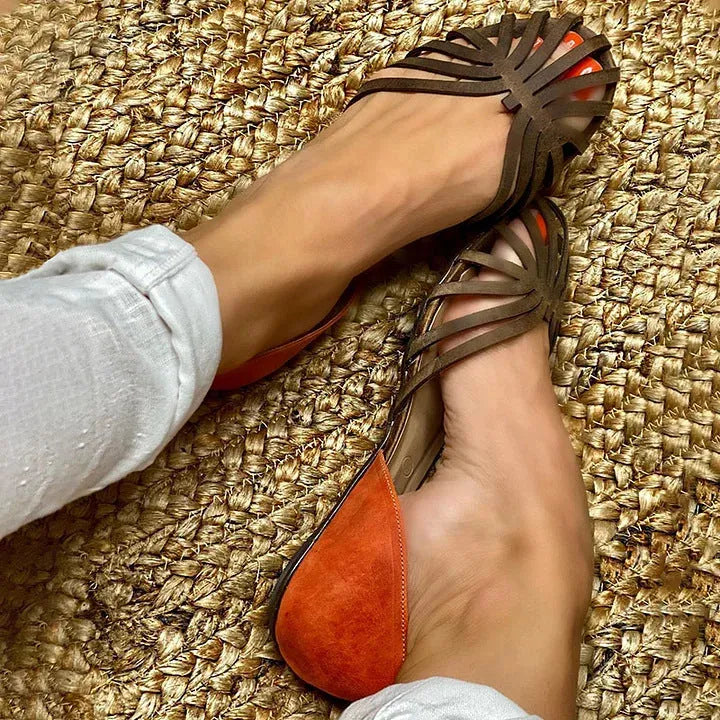 Women's dark brown leopard print flat sandals with a square buckle and herringbone toe detail.