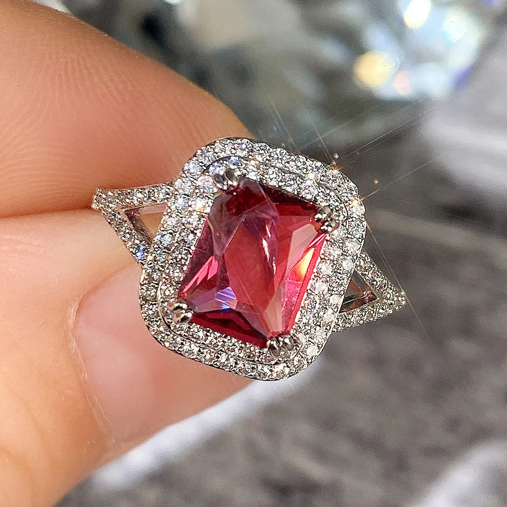 Women's copper square ring with red rhinestones, shown in a geometric princess cut design.
