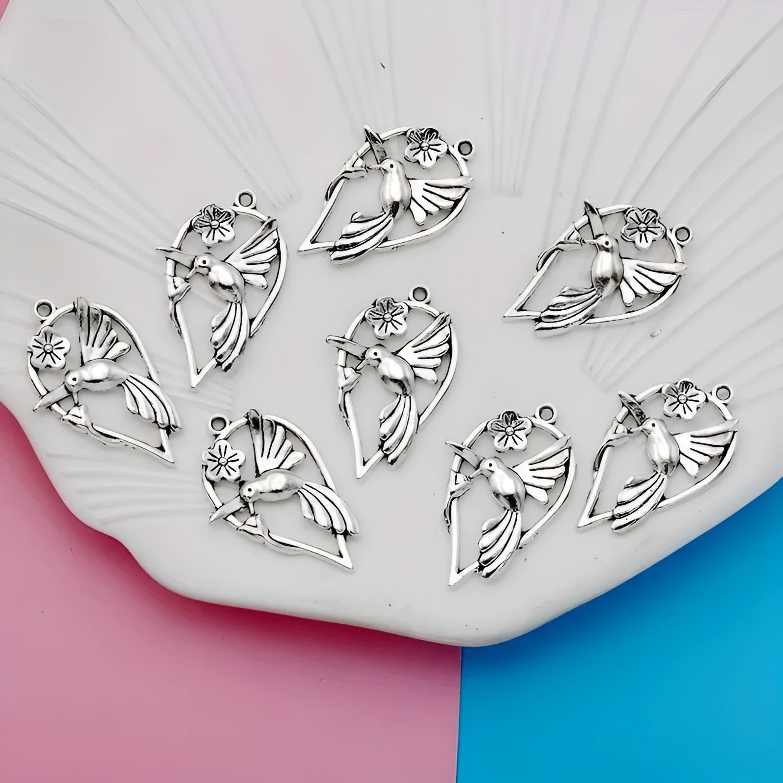 Close-up of a detailed magpie pattern alloy pendant with electroplated finish, showing attachment loop for DIY jewellery.