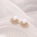 Close-up of women's retro silver fan-shaped rhinestone earrings with needle posts.