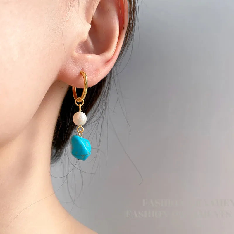 A pair of long and a pair of short geometric earrings with irregular turquoise and cultured pearls on copper ear clips.