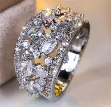 Round hollow women's fashion ring in copper, shown in platinum white and gold blue colour options.