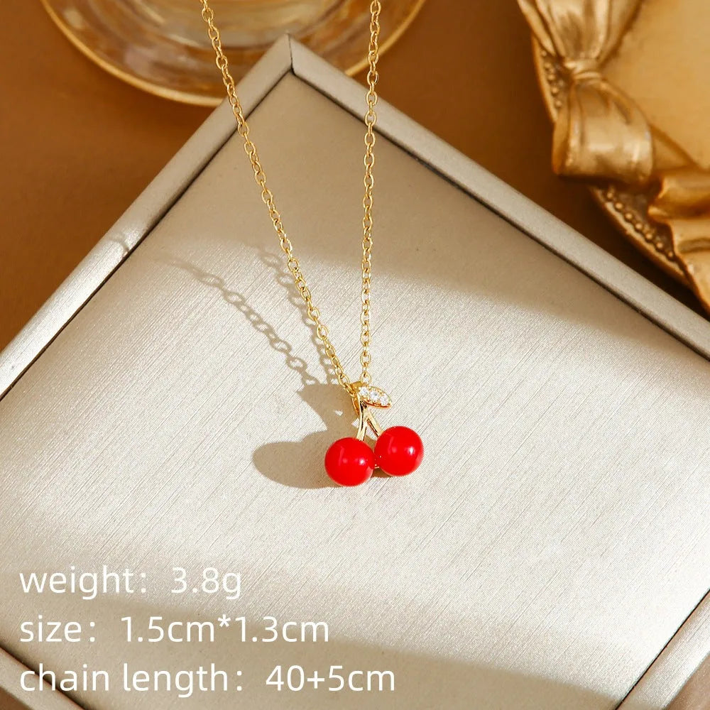 Golden pepper charm on an adjustable titanium steel necklace chain, laid flat.