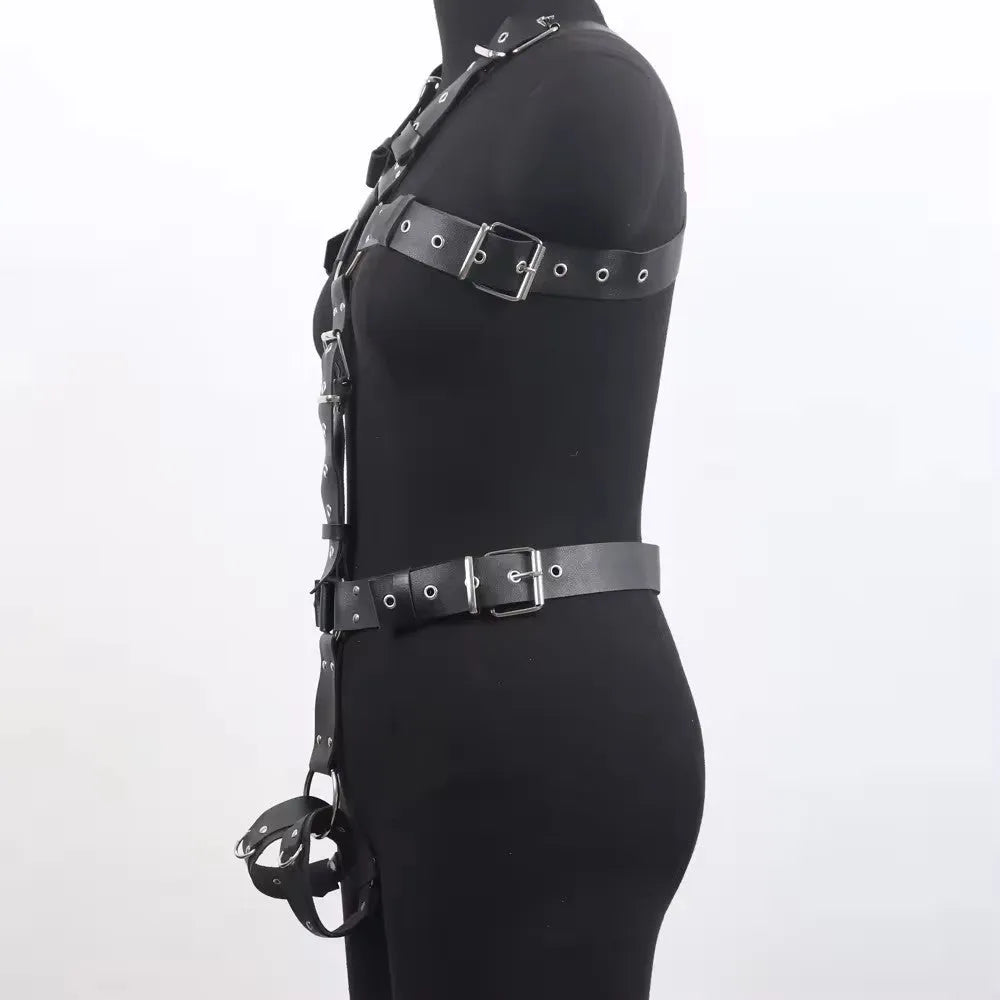 Black patent leather thin waist-cinching belt with a pin buckle on a mannequin.