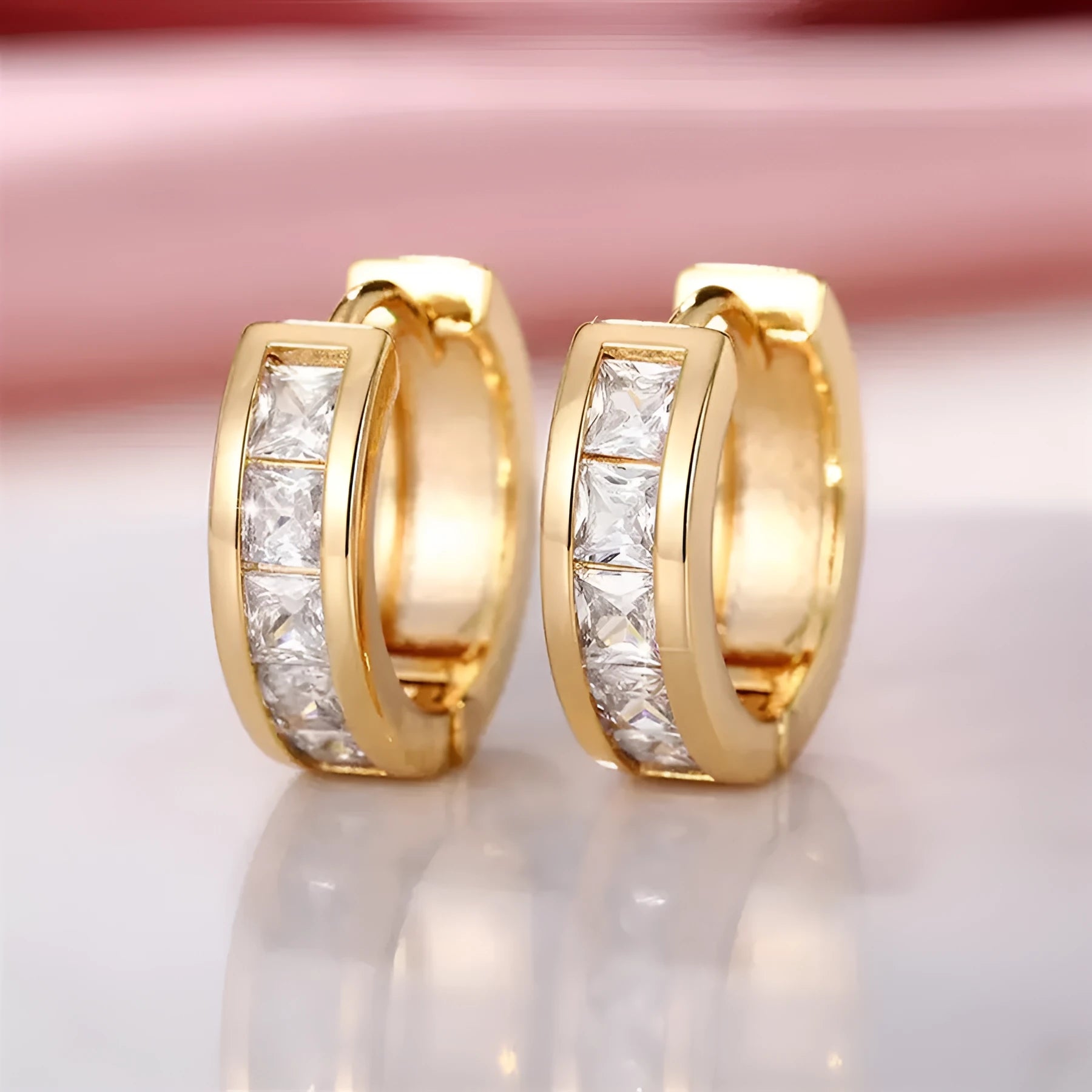 A pair of geometric quadrilateral fashion earrings for women in a gold colour finish.