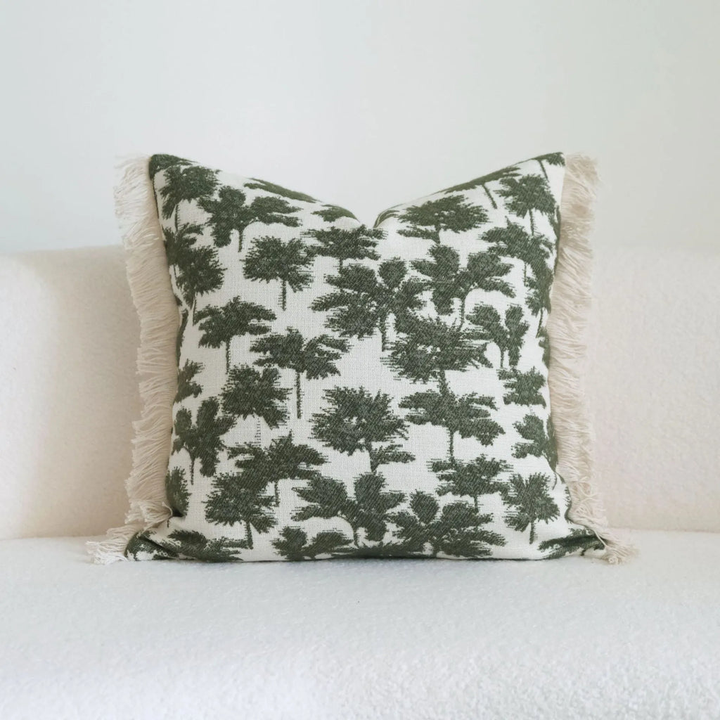 Green cotton and linen hotel pillow with decorative tassels and botanical patterns, shown with pillowcase and silk floss core.