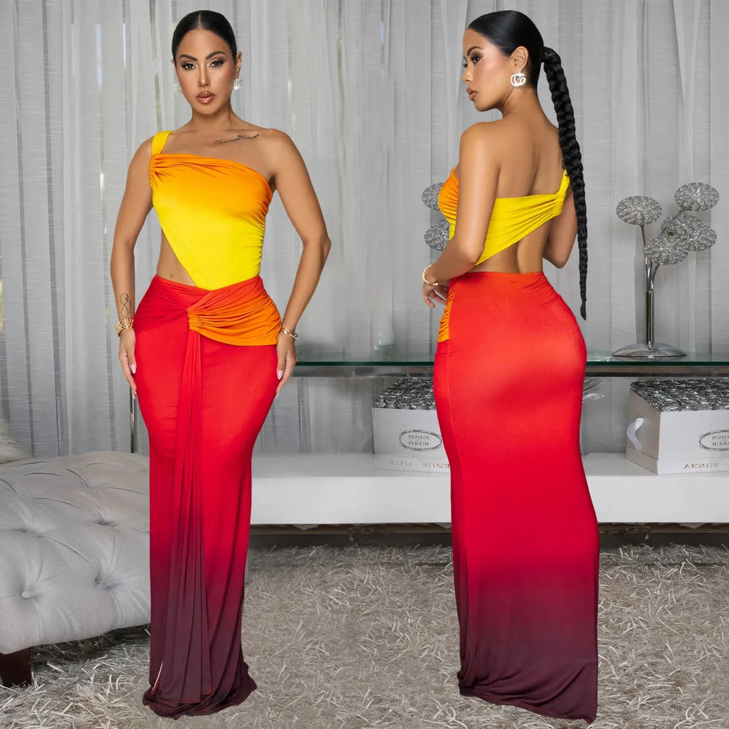 A woman wearing a long gradient colour dress with a cross-shoulder sleeveless design and high waist.