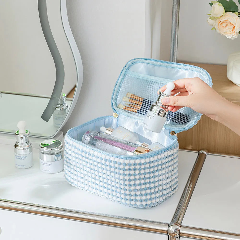Flannelette makeup bag travel set showing cube-shaped main bag and three smaller zip pouches in a blue with white dots colourway.