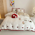 Winter Christmas cartoon bedding four-piece set with snowman milk pastry pattern on bed