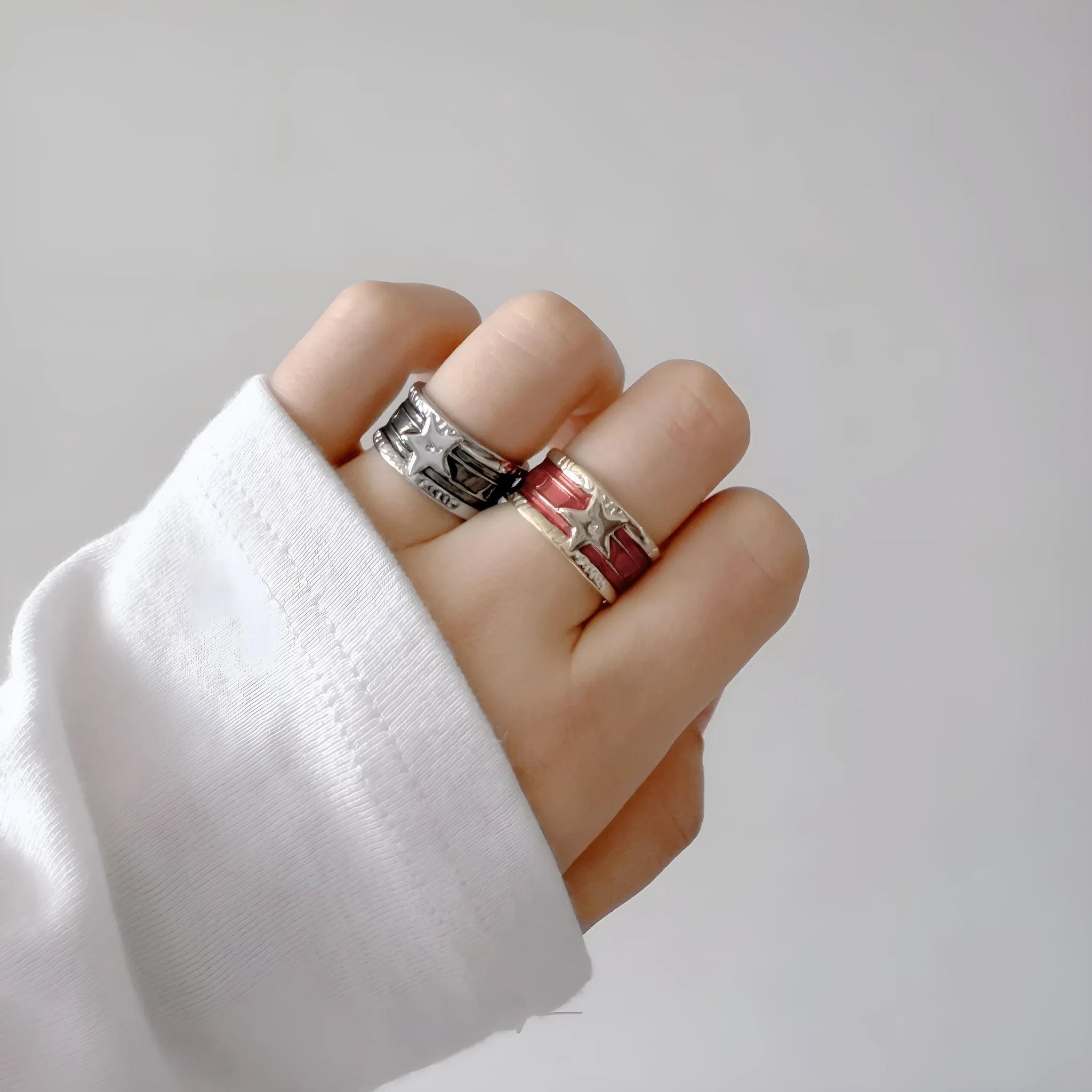 Adjustable geometric copper ring with a distressed finish in black, red, blue, and two-tone colour options.