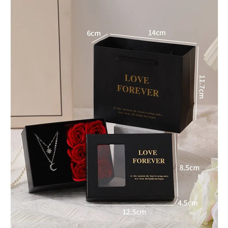 Six red soap roses in a black Korean-style gift box with a matching handbag