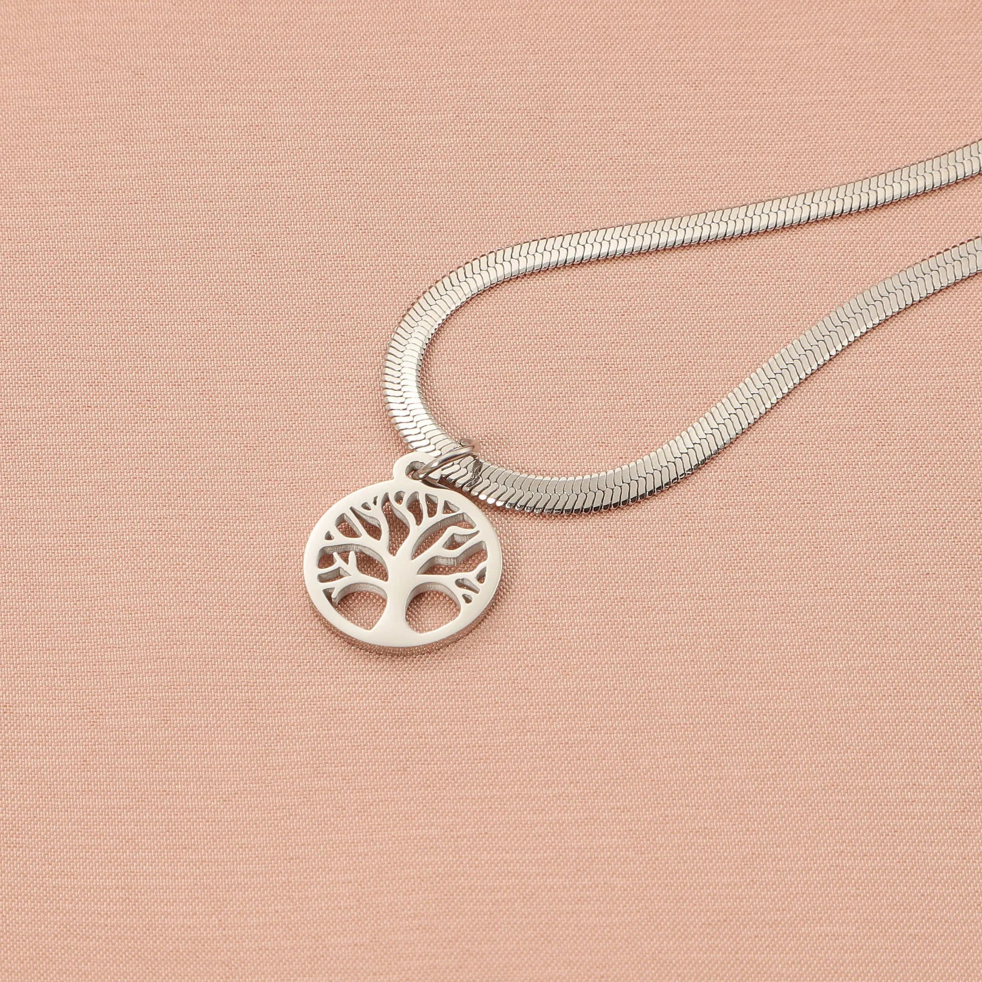 Stainless steel adjustable lucky tree necklace with a snake bone chain on a white background.