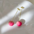 A pair of peach-shaped acrylic earrings on copper posts, shown in a choice of large or small sizes.