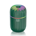 Mini green car-shaped USB aromatherapy humidifier on a desk