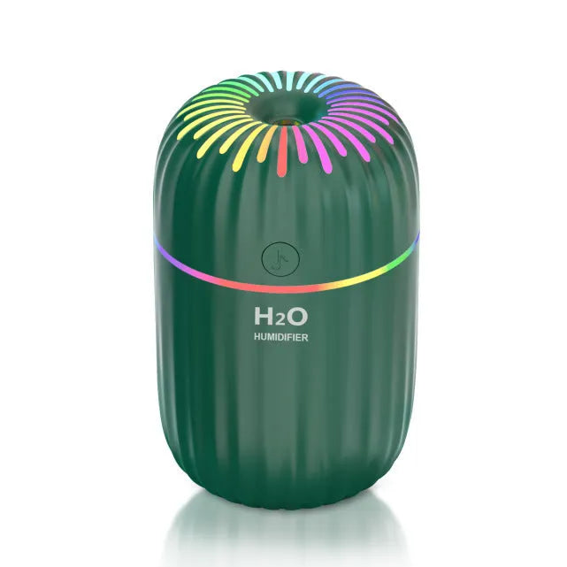 Mini green car-shaped USB aromatherapy humidifier on a desk