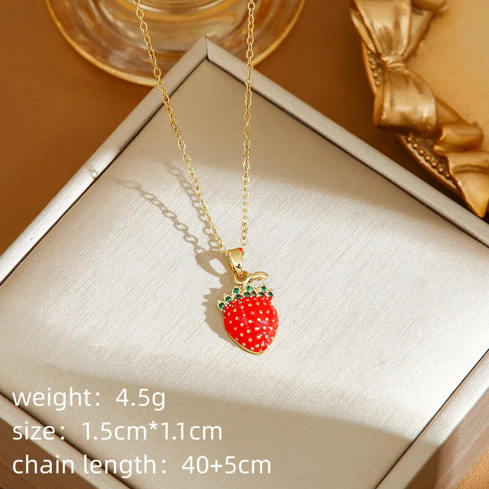 Golden pepper charm on an adjustable titanium steel necklace chain, laid flat.