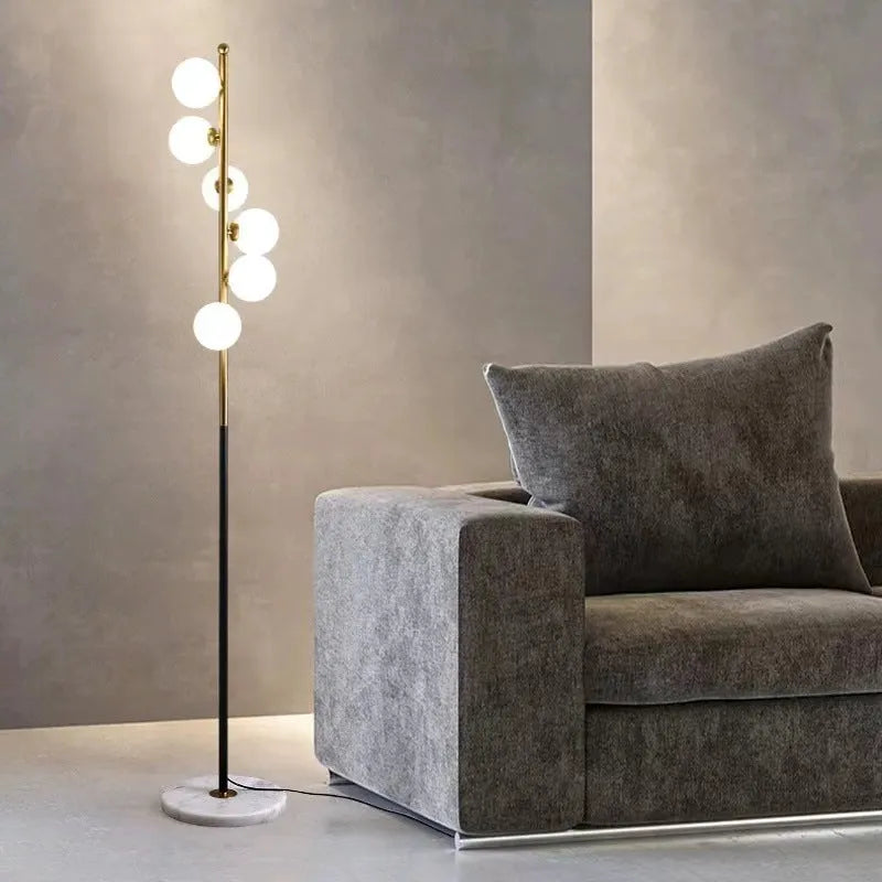 Tall minimalist Nordic floor lamp with wrought iron stand, glass details, and a marble foundation base.