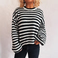 A woman's loose-fitting, long-sleeve stripe pullover sweater on a hanger in a khaki colour.