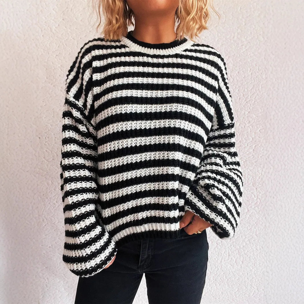 A woman's loose-fitting, long-sleeve stripe pullover sweater on a hanger in a khaki colour.