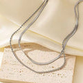 Women's silver geometric pendant necklace on a textured snake bone chain, adjustable from 21 to 50 cm.