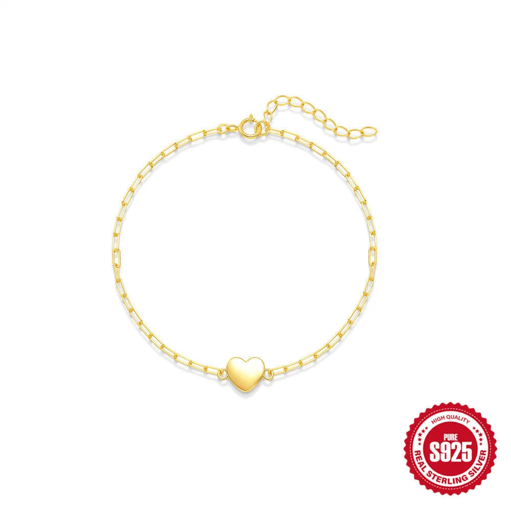 S925 sterling silver bracelet with heart charm and clip chain clasp in gold tone