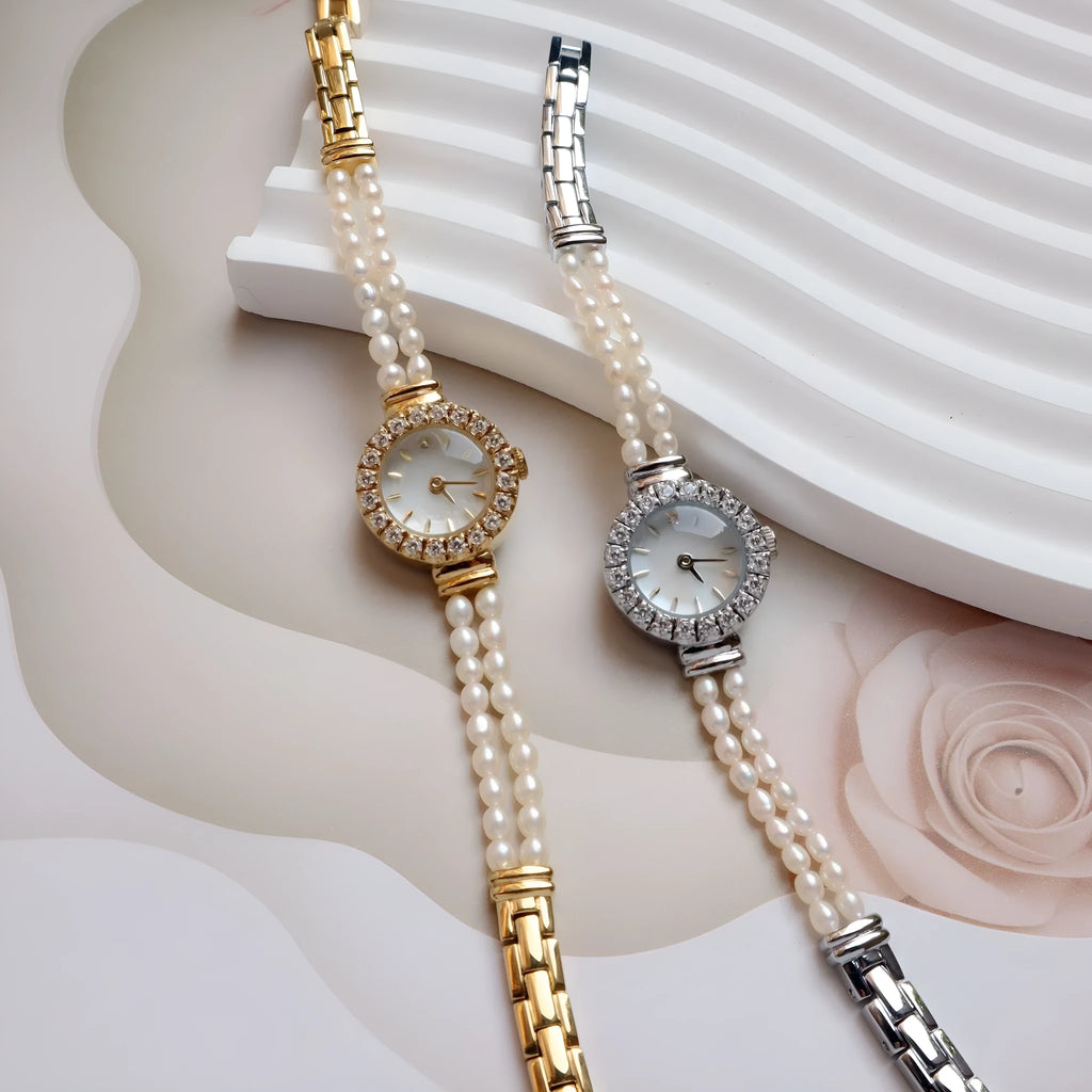 Women's light gold bracelet watch with natural freshwater pearls on a stainless steel strap, showing an 18mm round dial.
