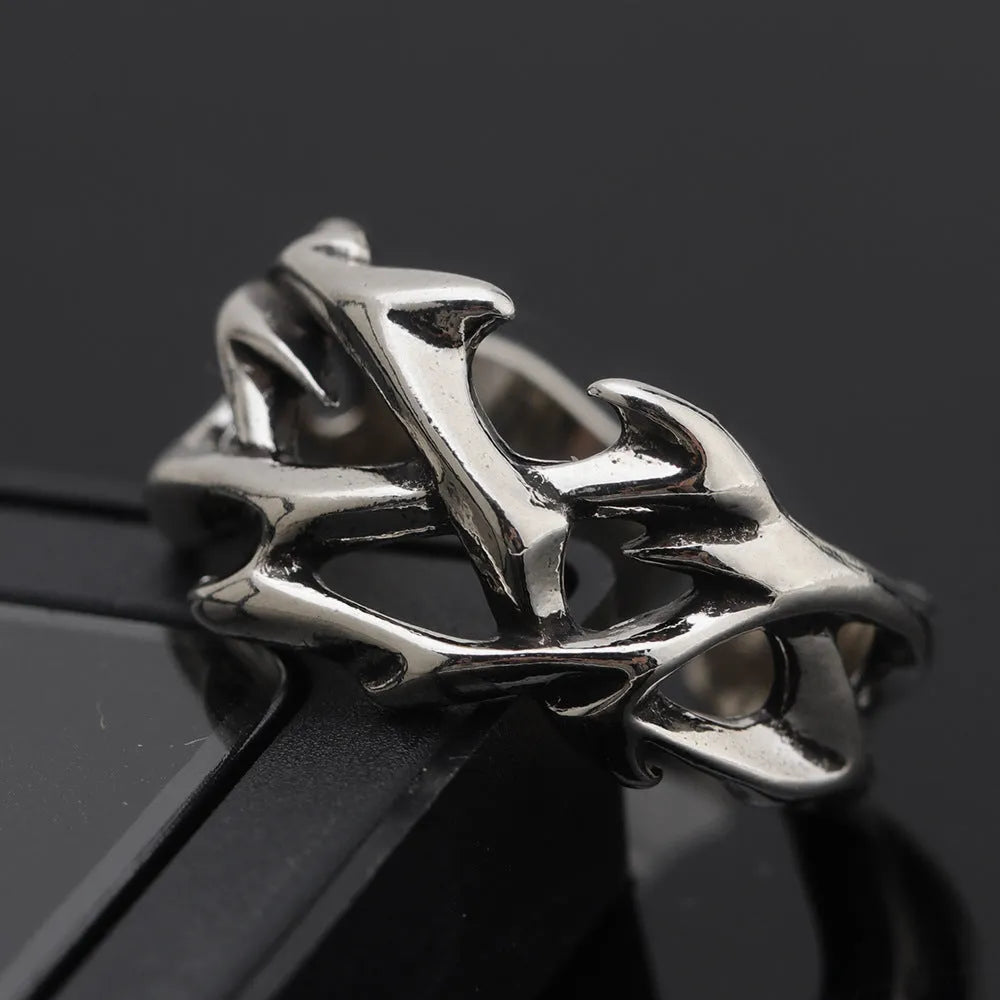 Copper geometric thorn flower ring with adjustable opening on a neutral background.