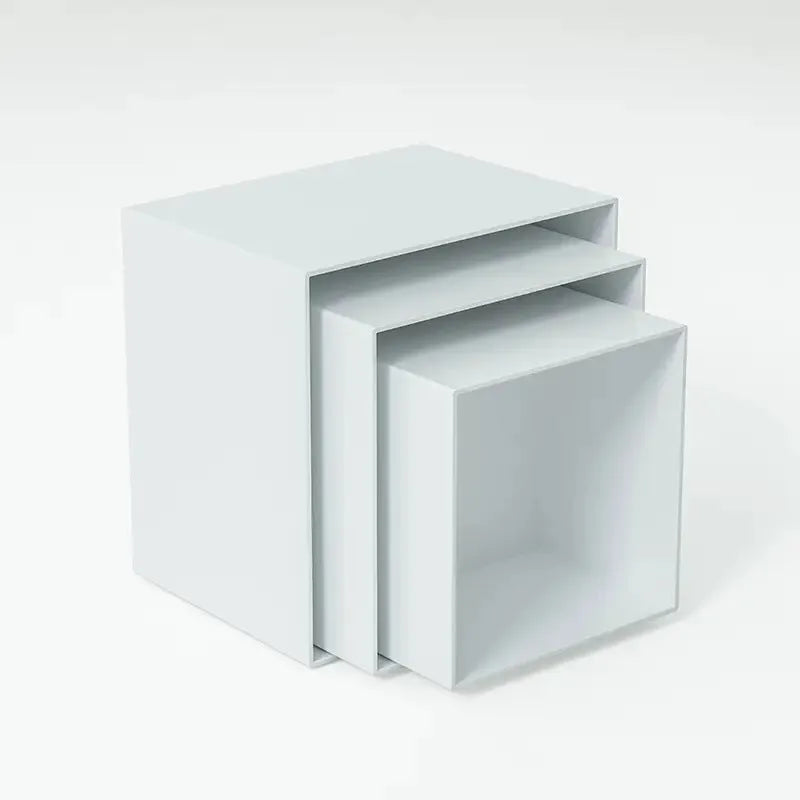 White acrylic six-piece cube dessert display stand arranged on a table with cupcakes.