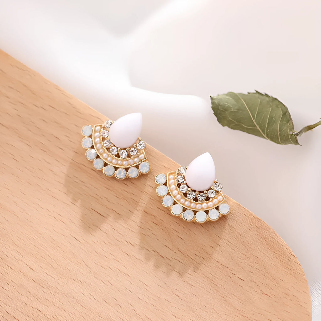Close-up of women's retro silver fan-shaped rhinestone earrings with needle posts.