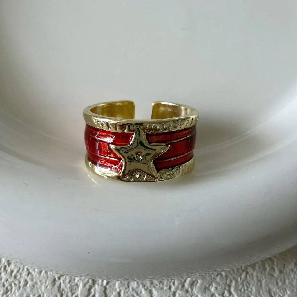 Adjustable geometric copper ring with a distressed finish in black, red, blue, and two-tone colour options.