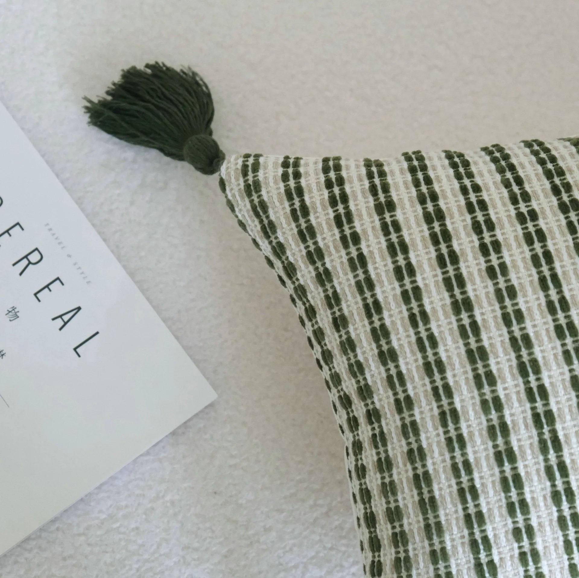 Green cotton and linen hotel pillow with decorative tassels and botanical patterns, shown with pillowcase and silk floss core.