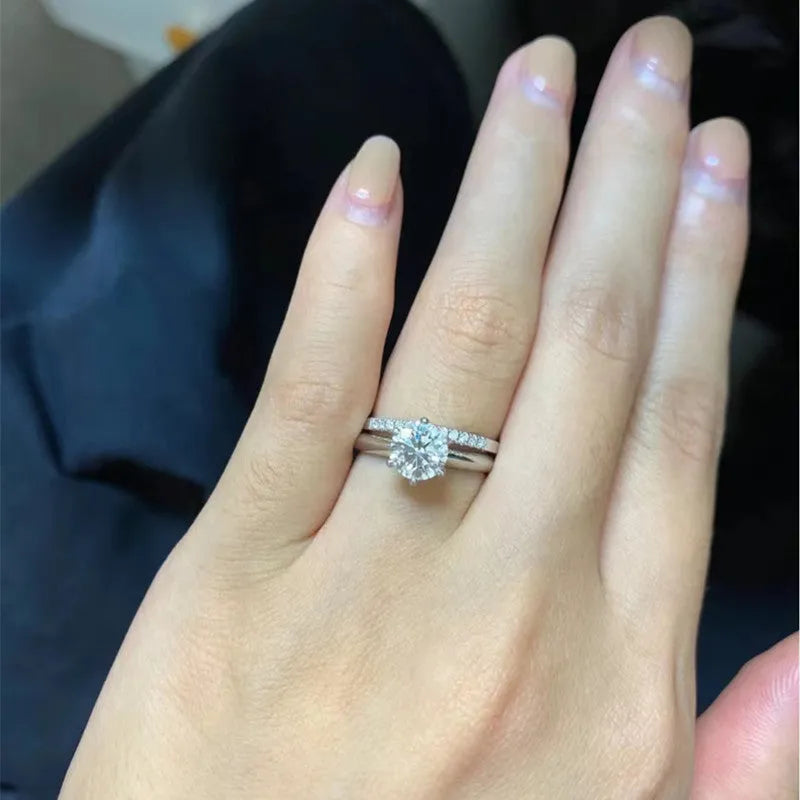 Silver Chinese-style couple's ring with dragon, phoenix, and heart design on an adjustable band.