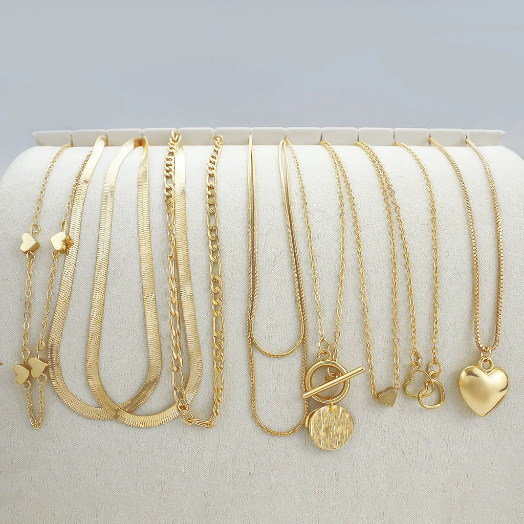 Gold tone women's necklace set with 10 ornamental pieces on snake bone chain