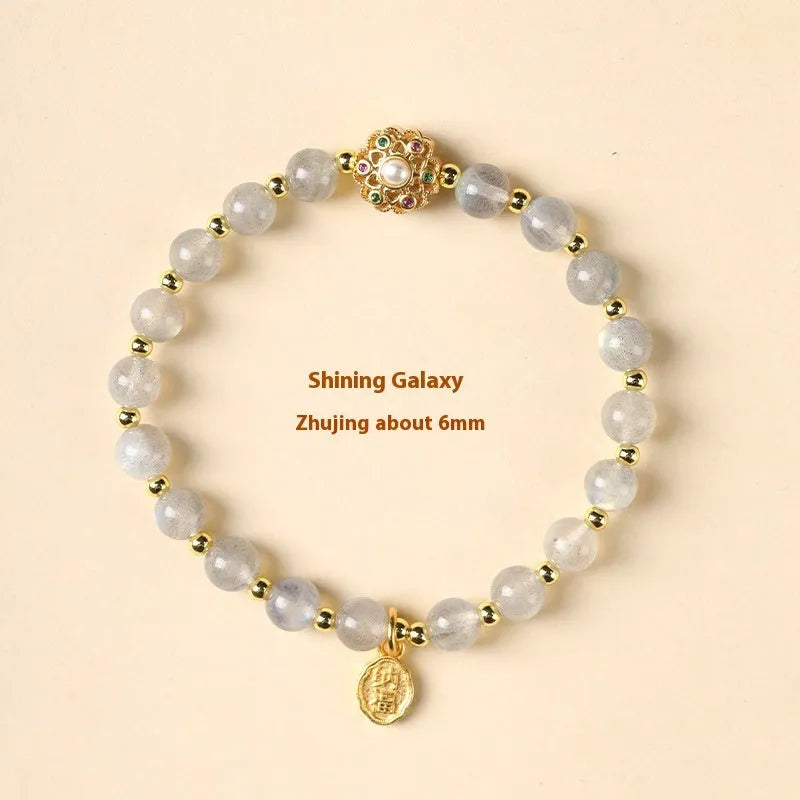 Hand-woven crystal bracelet with gray moonstone, sunstone, and strawberry quartz beads in pastoral style.