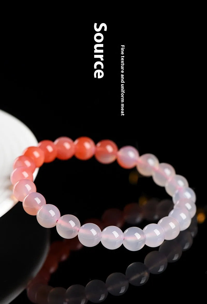 Yanyuan agate bracelet with gradient salt source coloured beads in a geometric shape on a wrist.