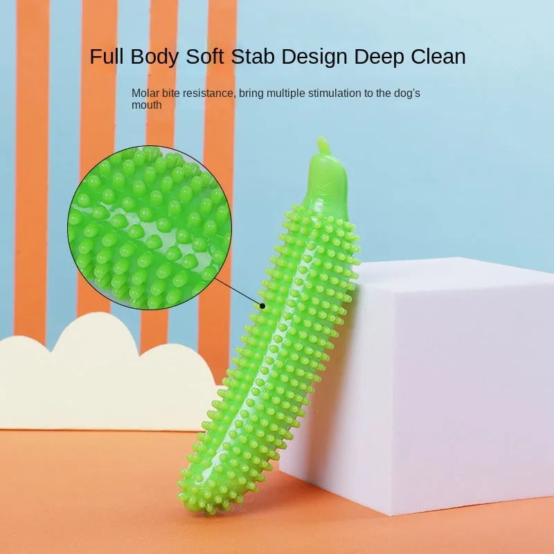 Green cucumber-shaped dog chew toy with a squeaker on a white background