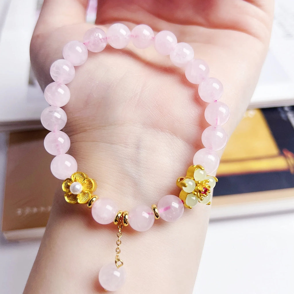 Pink crystal peach blossom bracelet with adjustable sliding knot closure on wrist