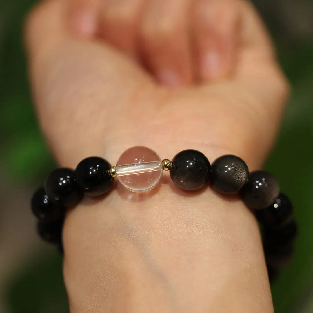 White and pink crystal bracelet with geometric Chinese design and cat eye obsidian elements