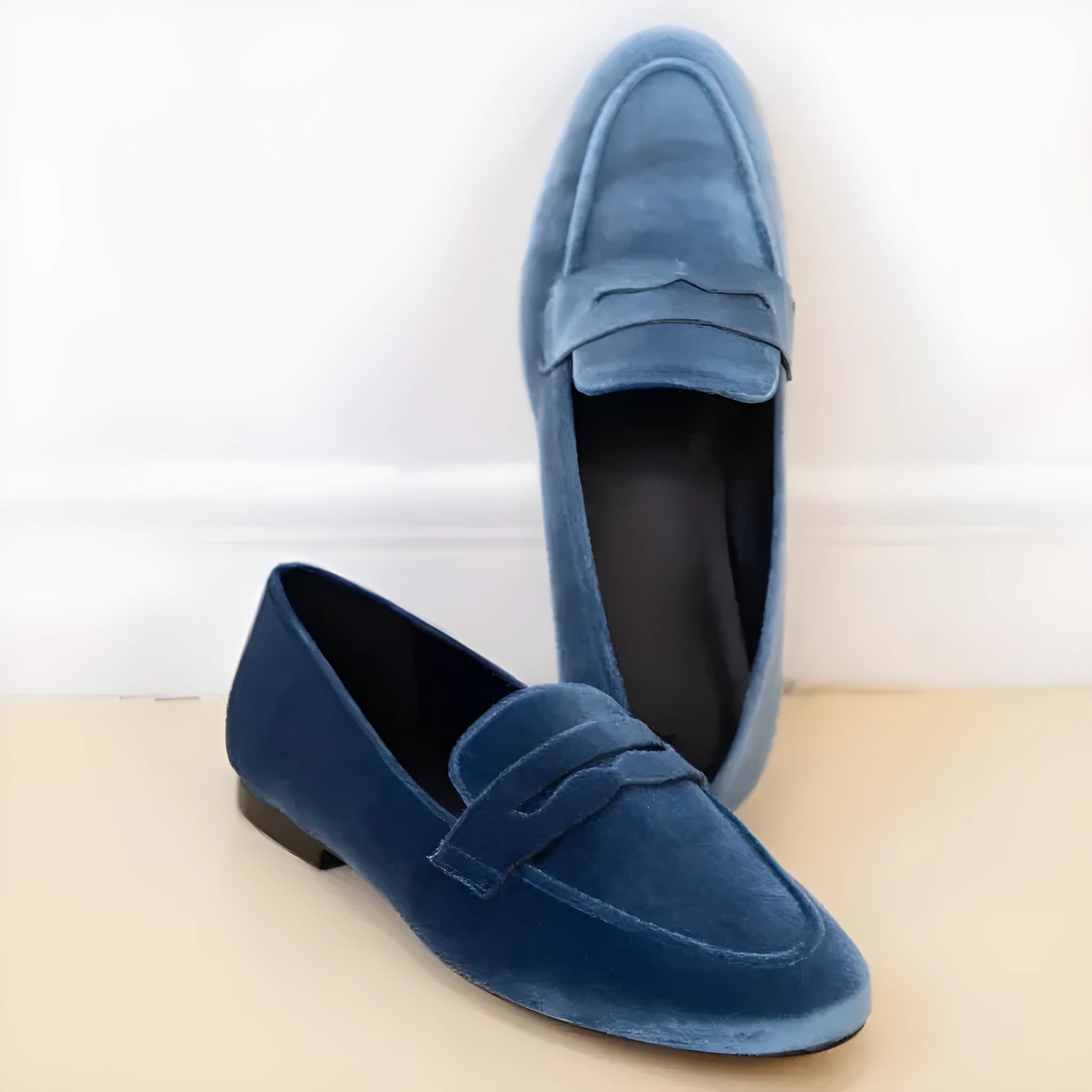 Blue leisure flat loafers with a black rubber sole, showing the suede-textured PU upper and round toe.