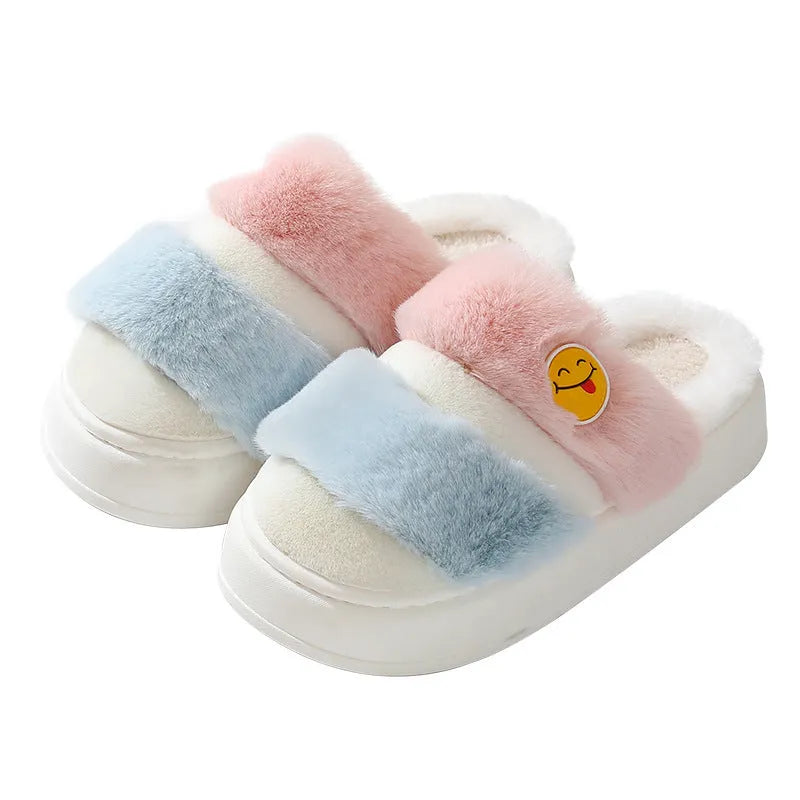 Pair of pink and green thermal cotton slippers with a plush upper and non-slip sole.