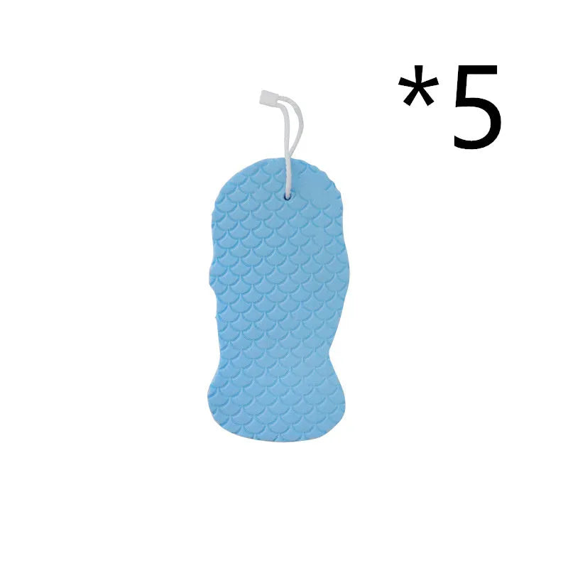 White 3D fish scale pattern bath sponge with hang loop on a bathroom background.