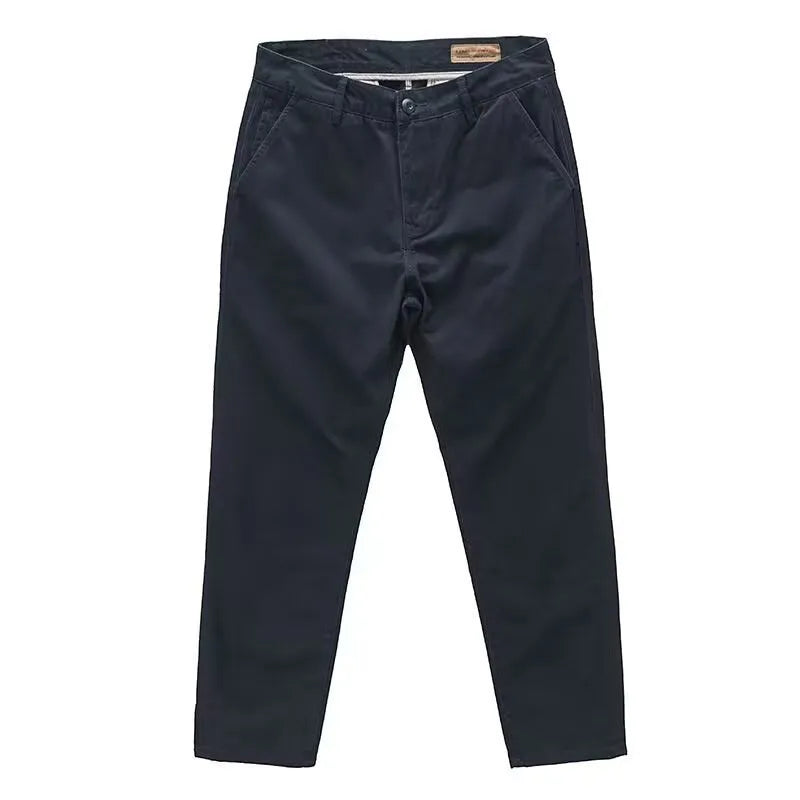 Man wearing slim-fit washed casual trousers in a neutral colour, showcasing the straight-leg style.