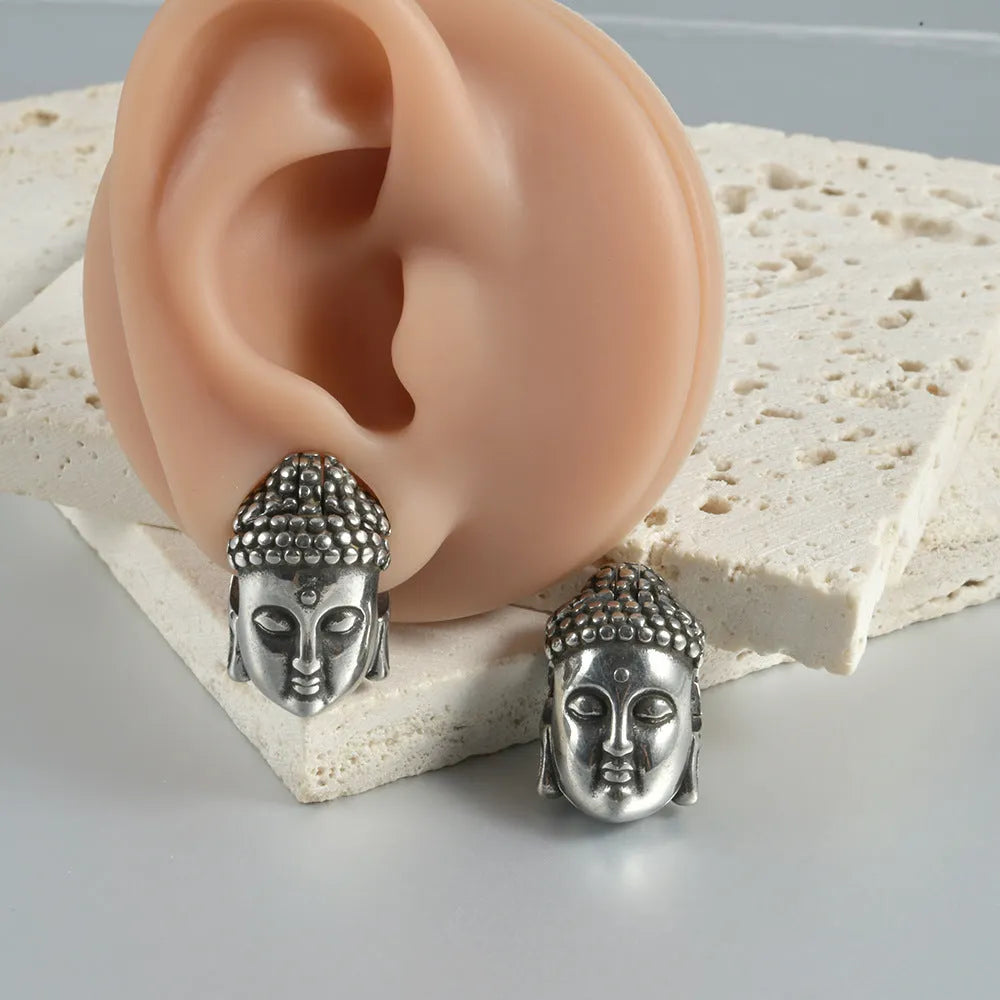 Stainless steel hollow skull and Buddha head design earrings in four colour options.