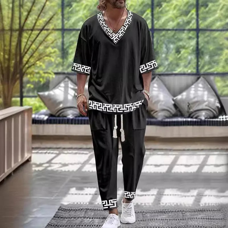 Cropped sleeve V-neck jacket and matching trousers suit on a hanger.