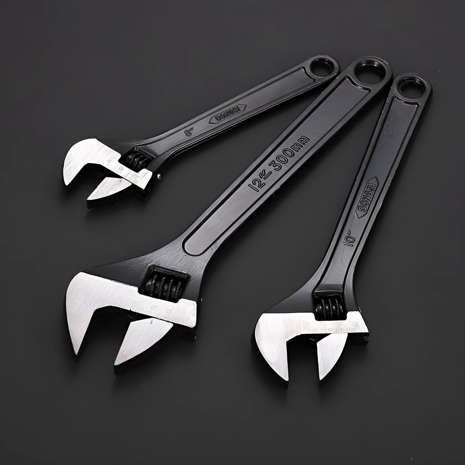 High carbon steel adjustable open-end wrench with black finish on a workbench.