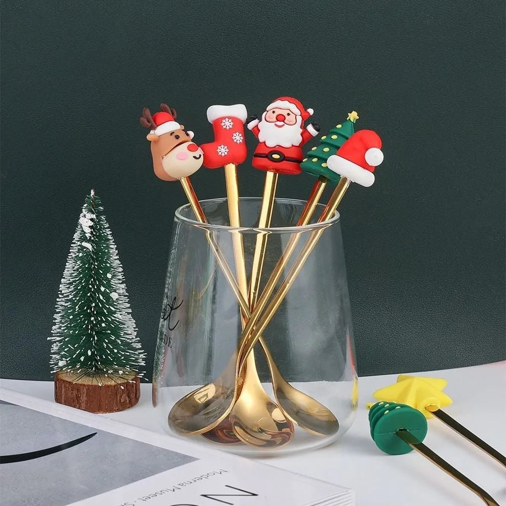 Stainless steel Christmas spoon and fork set with festive handle designs on a red background.