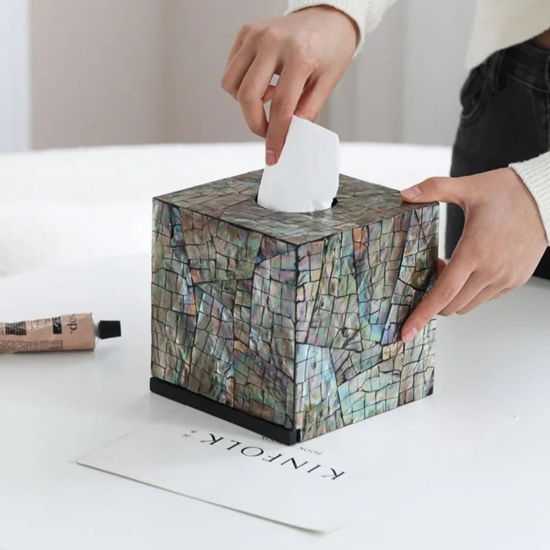 Black natural shell tissue storage box in rectangular and square shape options on a coffee table.
